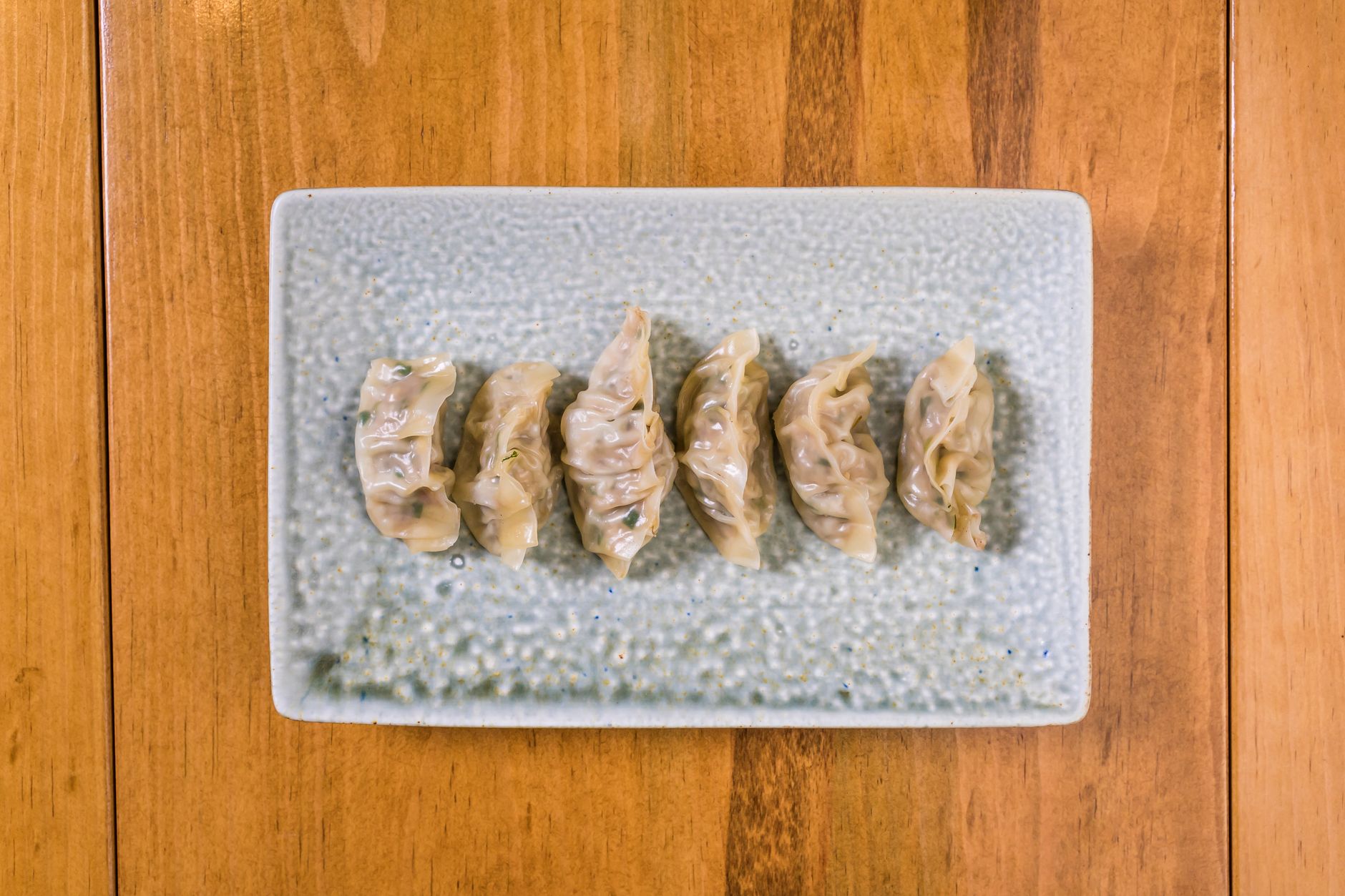 plate of dumplings on a wooden table